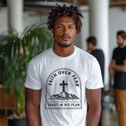 Faith Over Fear Trust In His Plan Comfort Colors T Shirt worn by man in modern setting with greenery.
