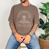 Faith Over Fear Trust In His Plan Comfort Colors T Shirt worn by a man with tattoos sitting near a plant.