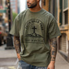 Man wearing Faith Over Fear Trust In His Plan Comfort Colors T Shirt, showcasing faith and courage in a city setting.