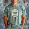 Man Of God Husband Father Leader T Shirt worn by a man, featuring a bold badge design that emphasizes faith and leadership.