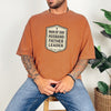 Man Of God Husband Father Leader T Shirt worn by a man, showcasing bold badge design and casual style.