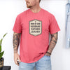 Man Of God Husband Father Leader T Shirt worn by man with tattoos, in a casual setting with indoor plants.