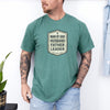 Man Of God Husband Father Leader T Shirt worn by a man, featuring a bold badge design.