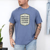 Man Of God Husband Father Leader T Shirt worn by a man with tattoos, showcasing a bold badge-style design.