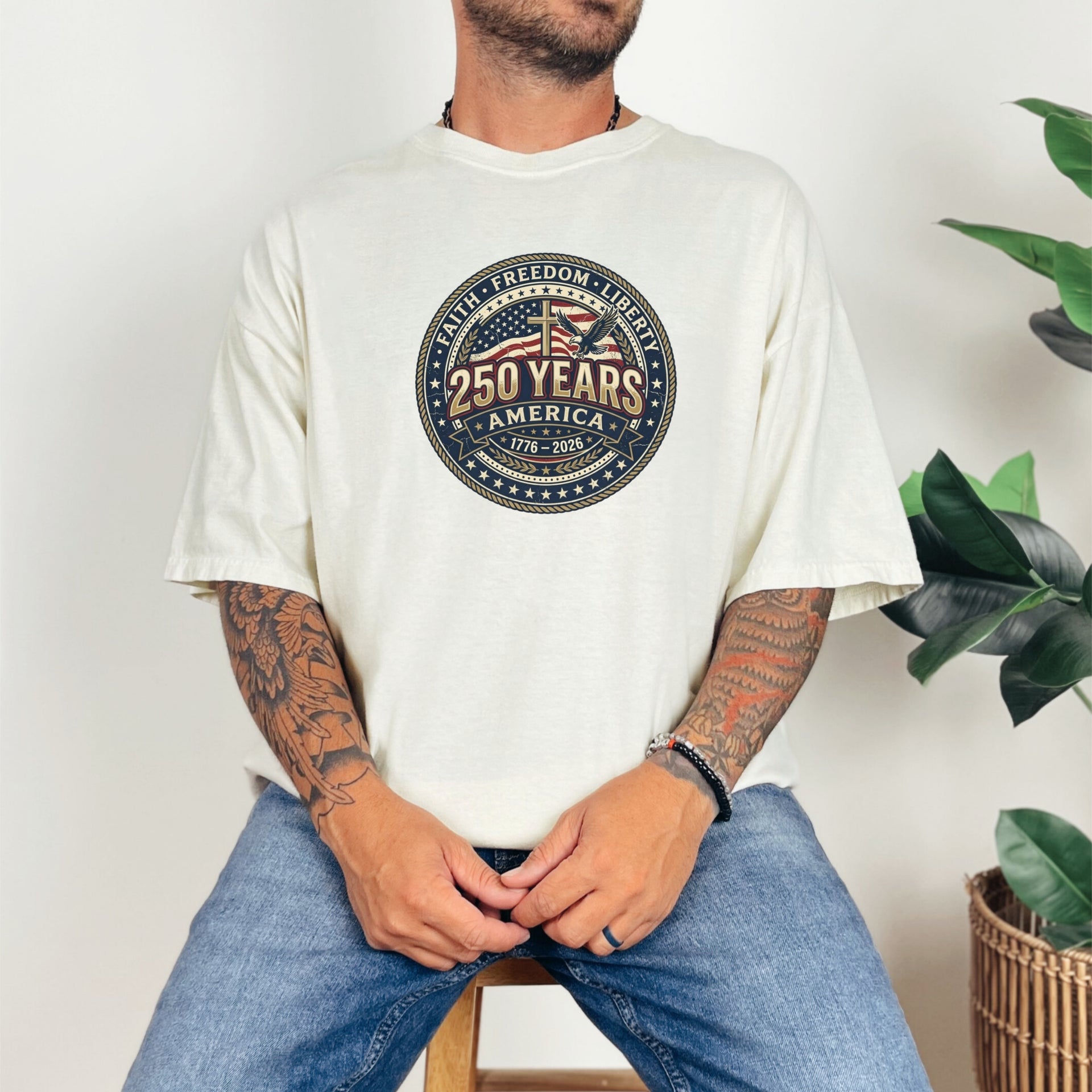 Man wearing 250 Years America Badge T-Shirt featuring vintage badge design and American flag elements.