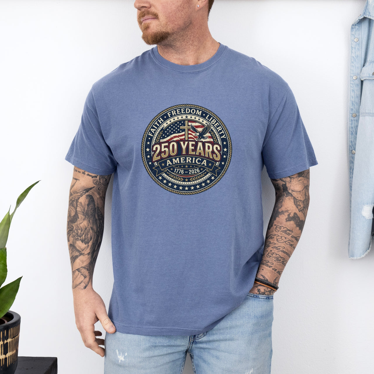 Man wearing a 250 Years America Badge T-Shirt with a vintage badge design and American flag elements.