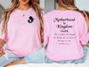 Woman wearing a pink Motherhood Is Kingdom Work T Shirt with silhouette design and inspirational text.