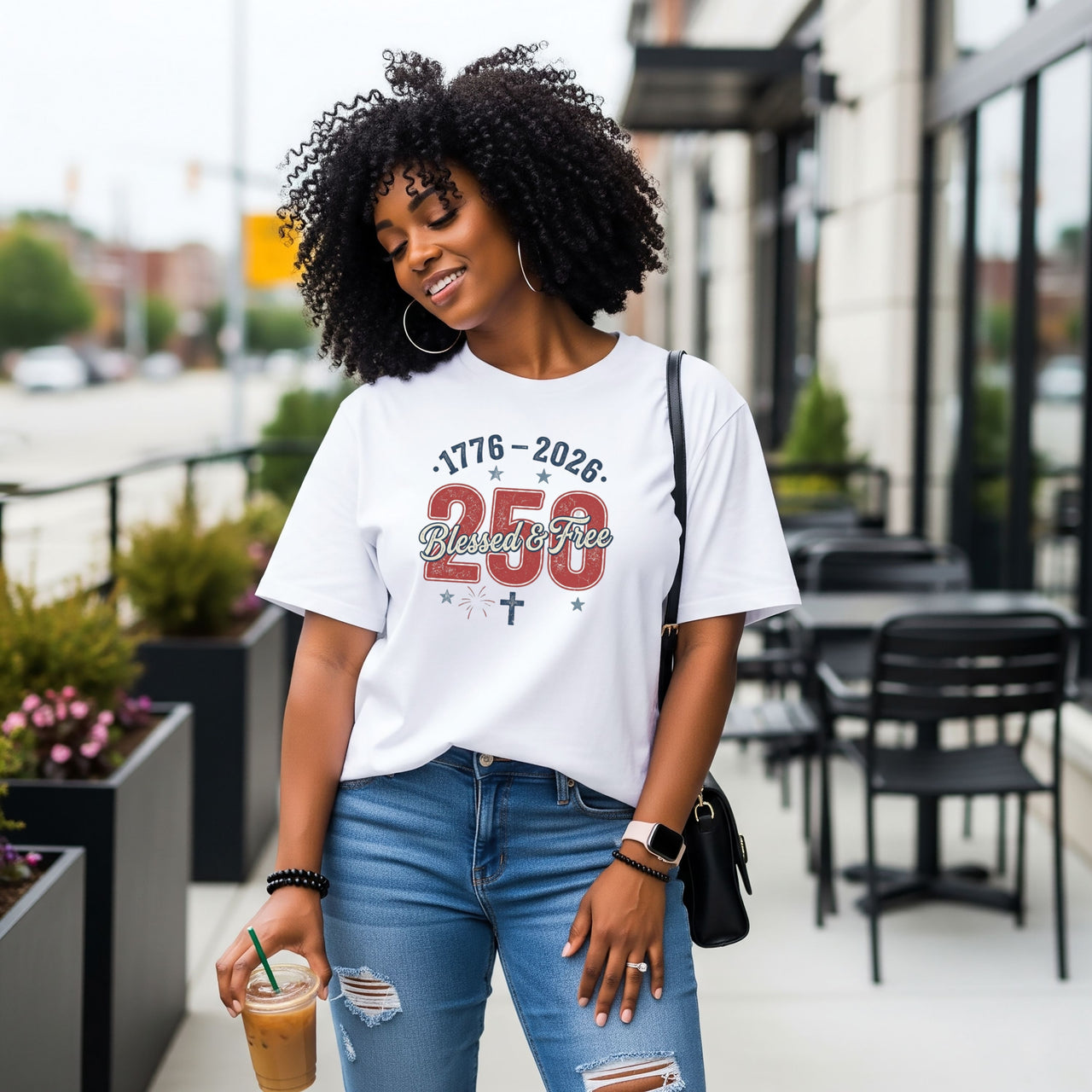 Woman wearing Blessed & Free 250 T-Shirt in a casual outdoor setting, celebrating freedom and faith.