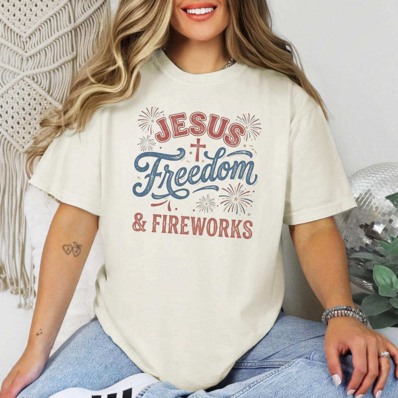 Jesus Freedom & Fireworks T-shirt featuring a bold graphic on a cream-colored shirt.