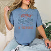 Jesus Freedom & Fireworks T-shirt displayed on a model, featuring a blue color and festive design for Independence Day.
