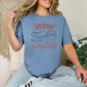 Jesus Freedom & Fireworks T-shirt displayed on a model, featuring a blue color and festive design for Independence Day.