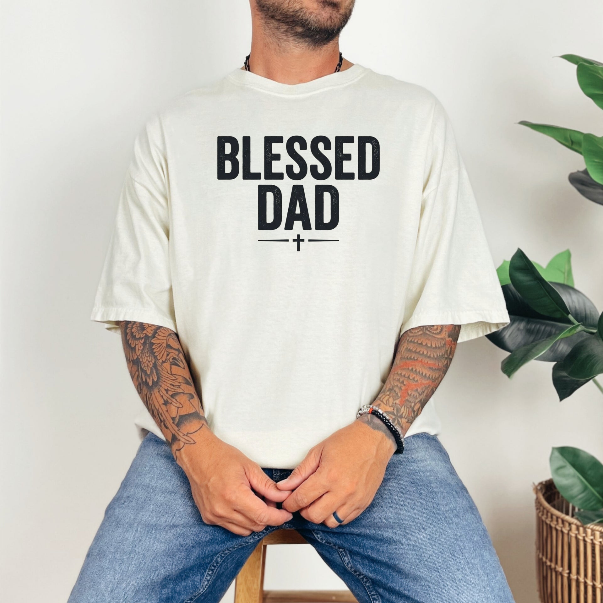 Man wearing a Blessed Dad Cross T Shirt with bold lettering and a cross design, showcasing faith and fatherhood.