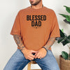 Man wearing a Blessed Dad Cross T Shirt in brown with bold text design, showcasing faith and fatherhood.