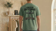 Man wearing a Forged By Brotherhood Cross T Shirt, showcasing Christian brotherhood apparel with a bold cross design.