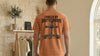 Back view of a man wearing a Forged By Brotherhood Cross T Shirt, showcasing Christian brotherhood apparel design.
