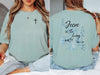 Jesus living water t shirt in soft green color, featuring inspirational design with scripture on the back.