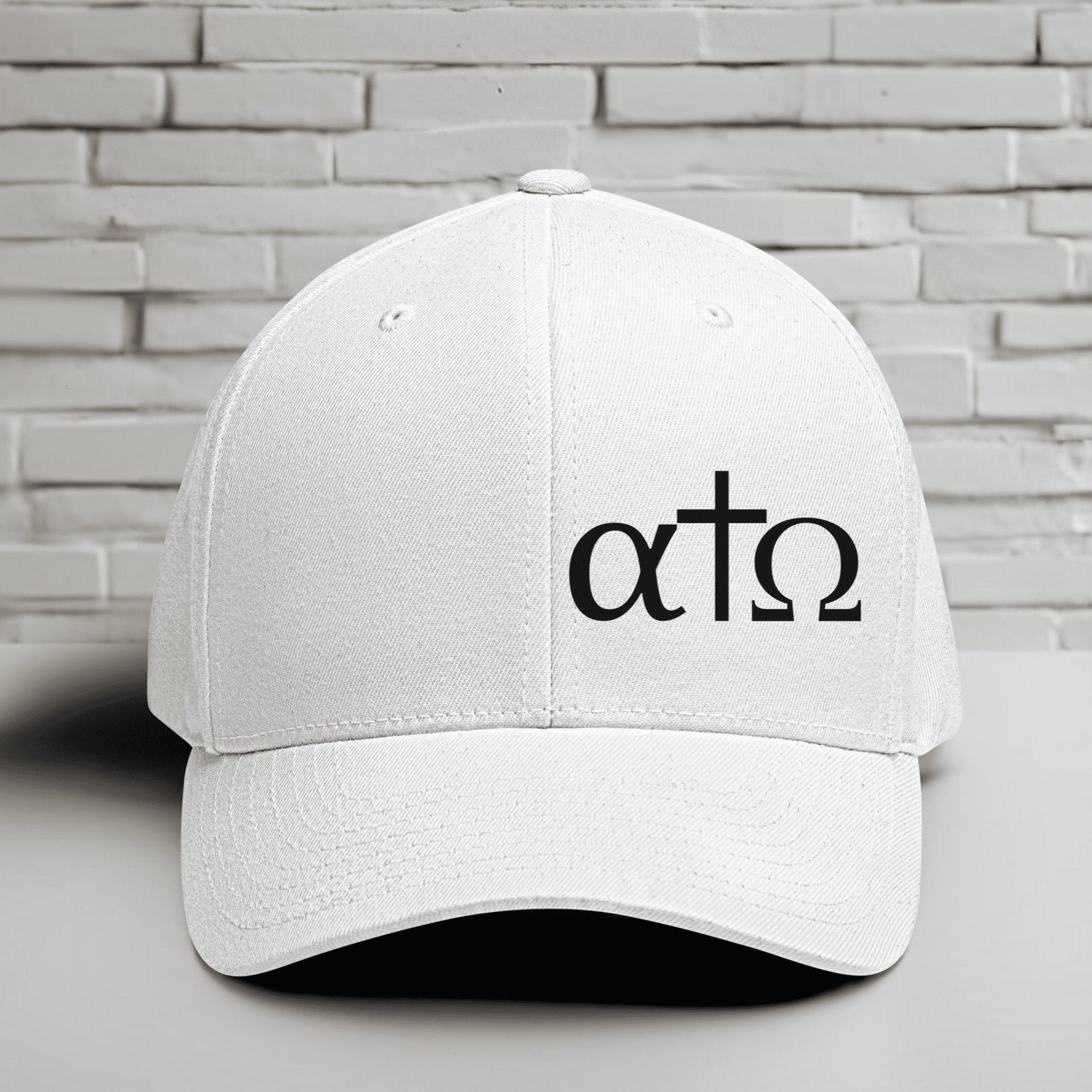 Alpha Omega Cross black hat with Greek letters embroidered on a white Flexfit cap, representing Christian faith.