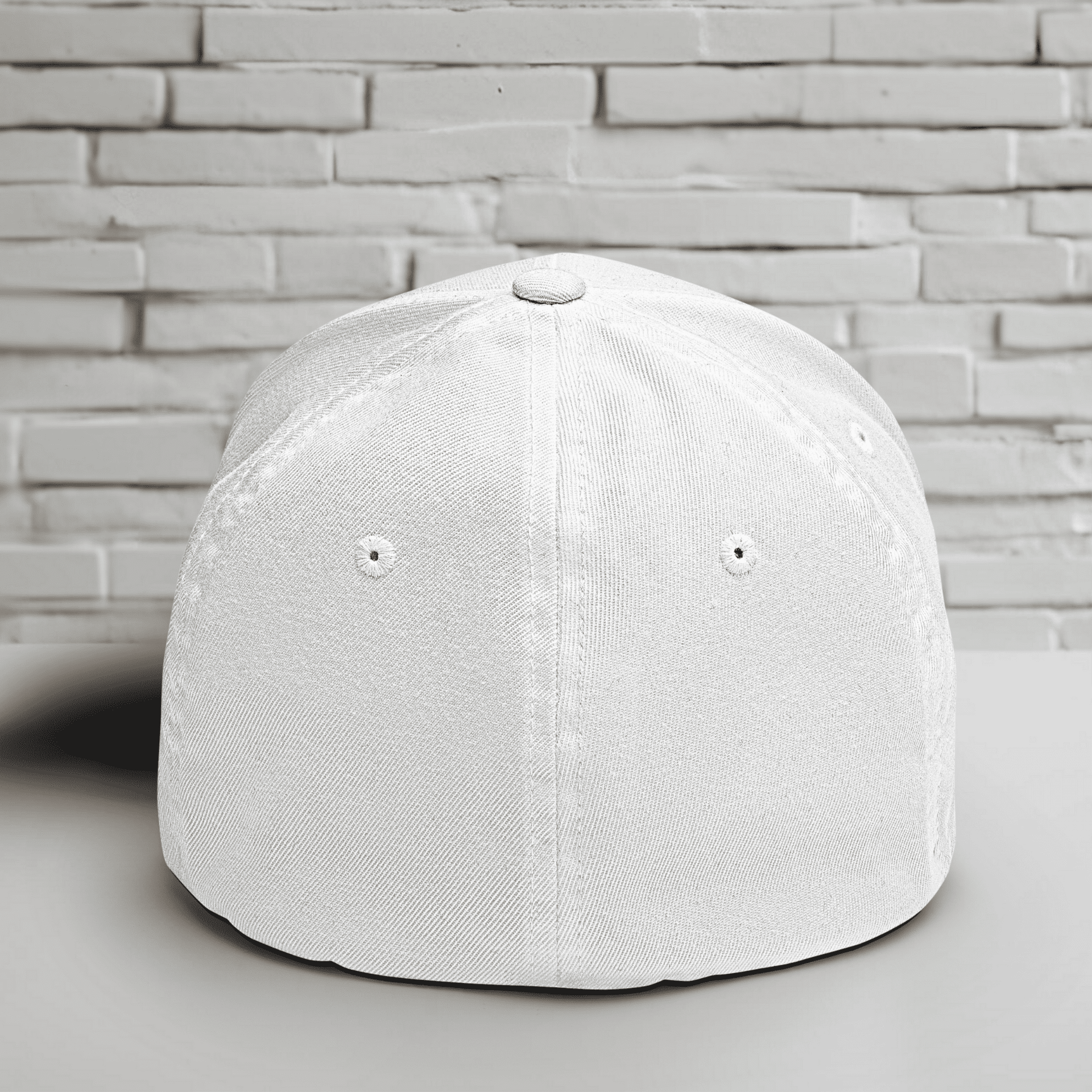 Back view of a white Flexfit hat, showcasing its structured design and clean silhouette.