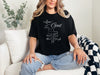 Love God t shirt featuring a stylish design with a cross and the scripture Mark 12:30 on a woman in casual attire.