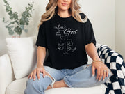 Love God t shirt featuring a stylish design with a cross and the scripture Mark 12:30 on a woman in casual attire.