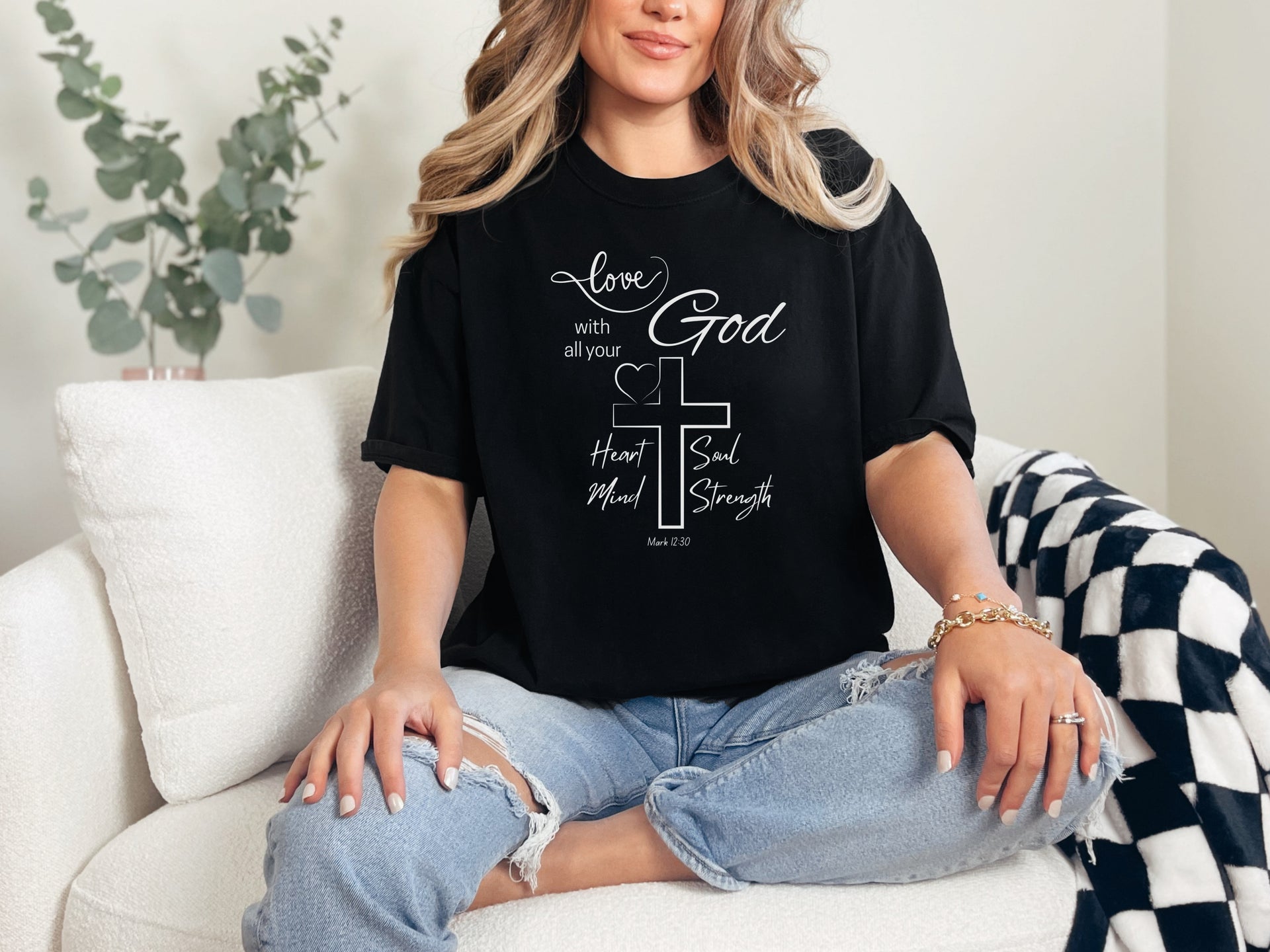 Love God t shirt featuring a stylish design with a cross and the scripture Mark 12:30 on a woman in casual attire.
