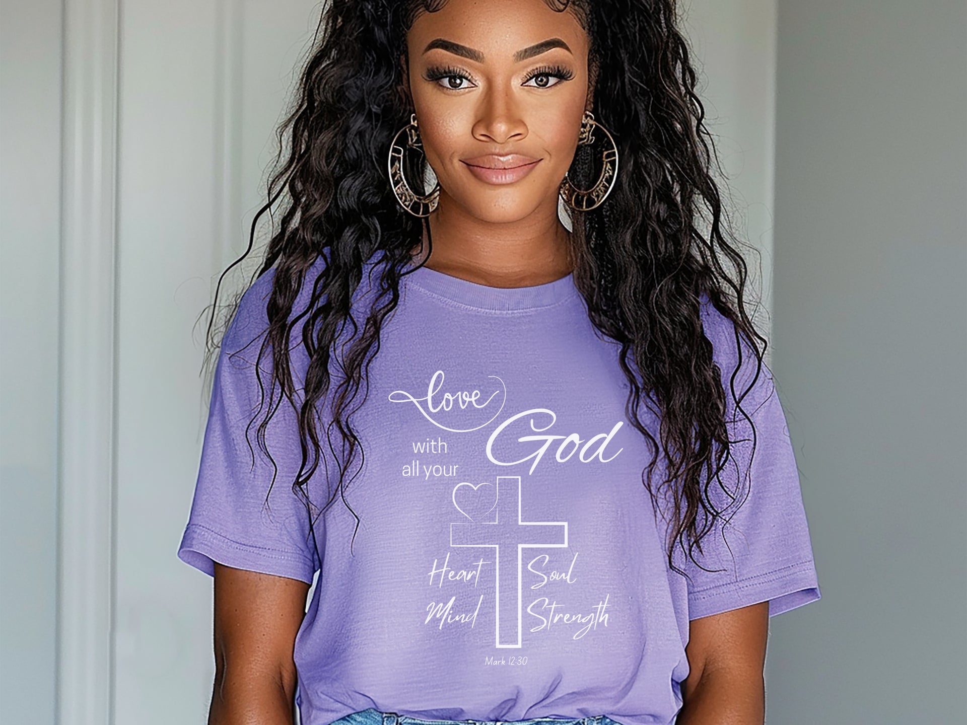 Model wearing a purple Love God T Shirt with scripture design, showcasing faith and style.