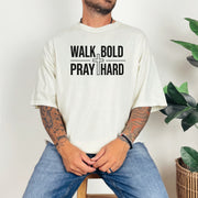 Model wearing a Walk Bold Pray Hard Christian cross t shirt, featuring a bold graphic design and relaxed fit.
