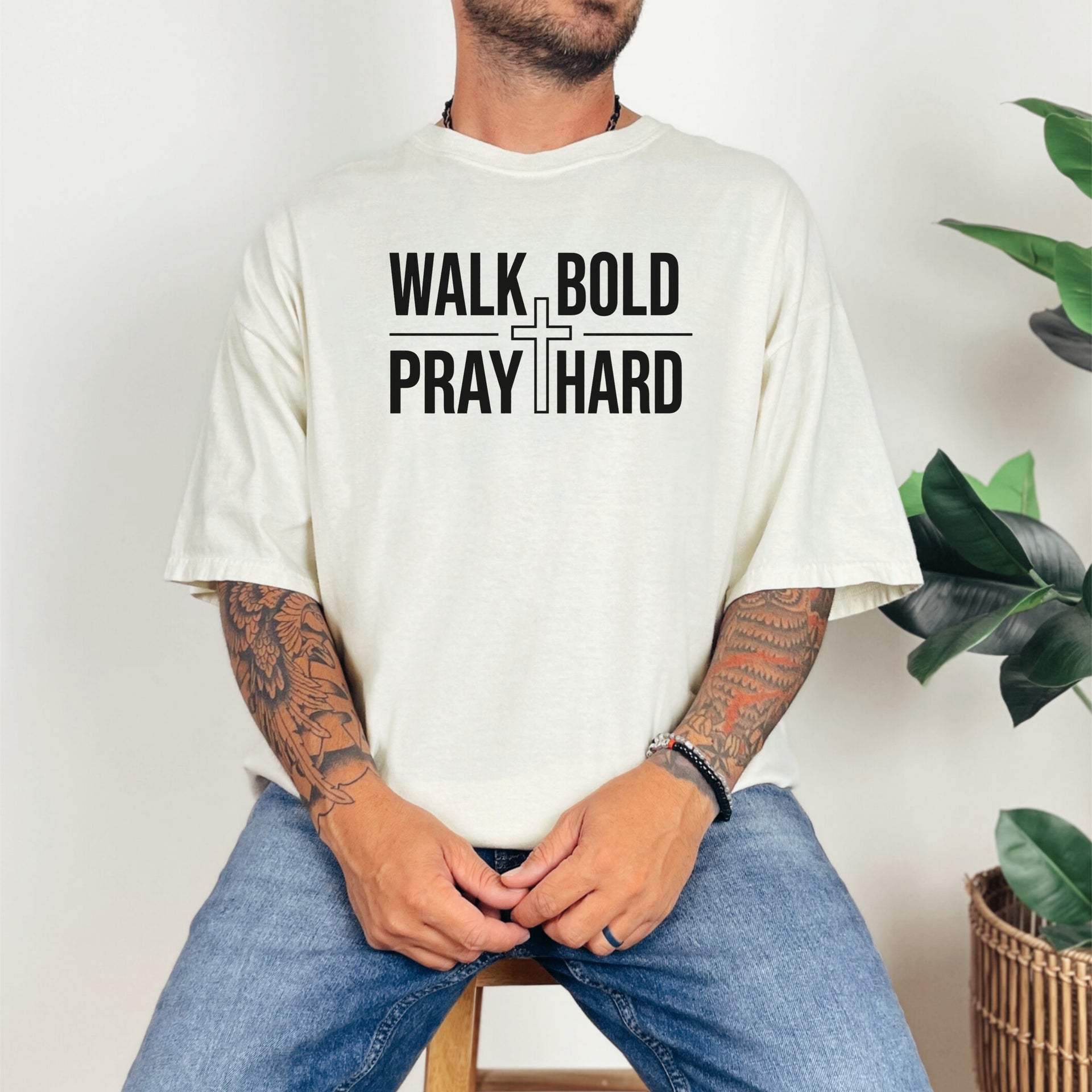 Model wearing a Walk Bold Pray Hard Christian cross t shirt, featuring a bold graphic design and relaxed fit.