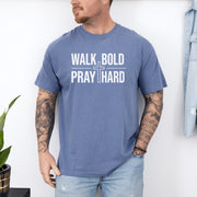 Man wearing Walk Bold Pray Hard Christian cross t shirt, showcasing bold design and relaxed fit.