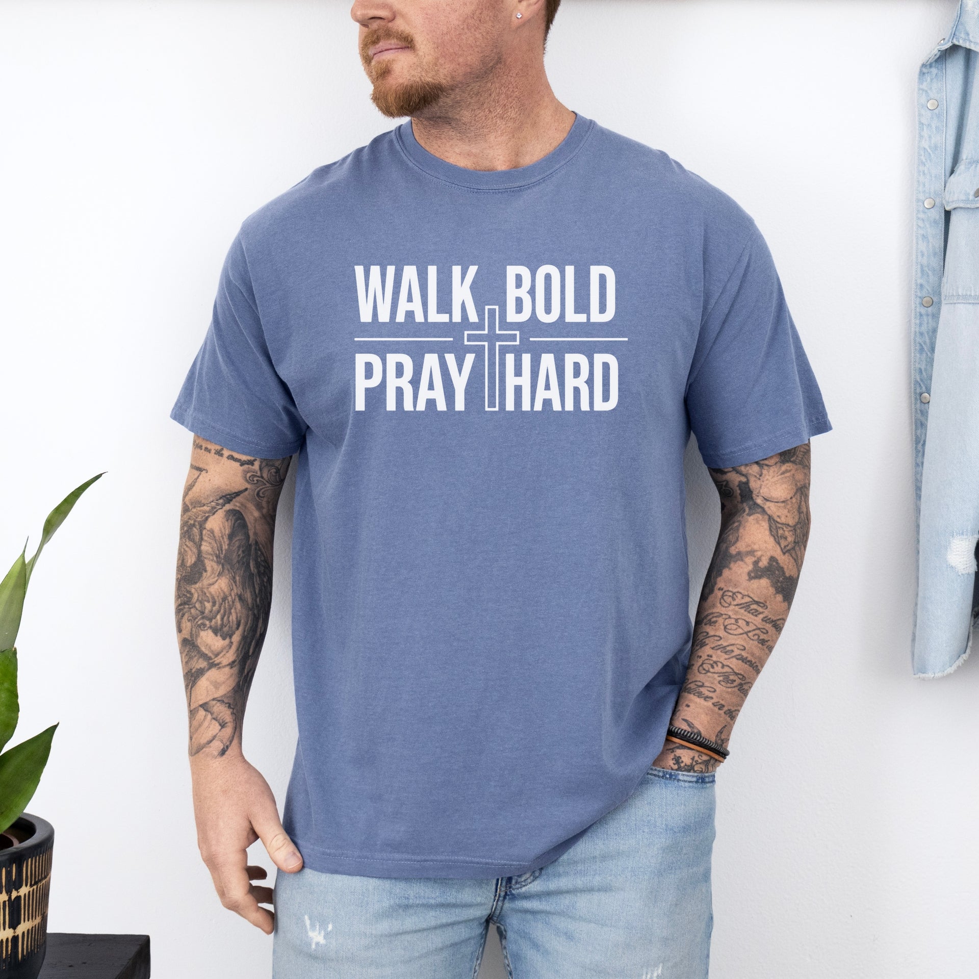 Man wearing Walk Bold Pray Hard Christian cross t shirt, showcasing bold design and relaxed fit.