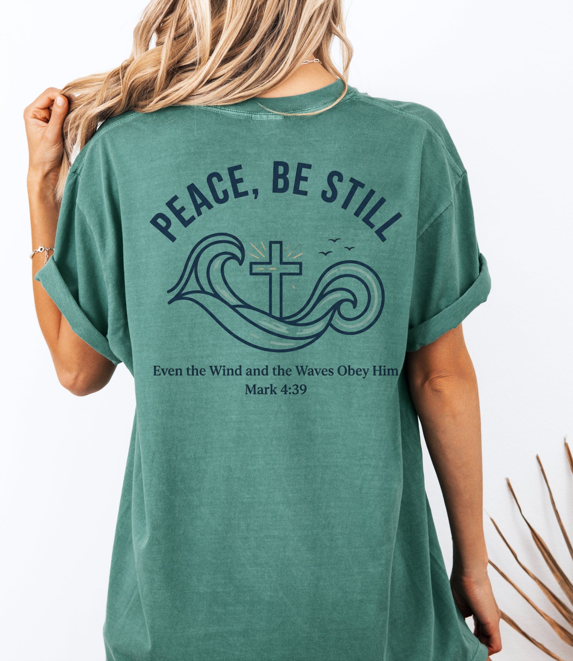 Peace Be Still T Shirt design featuring waves and a cross, symbolizing calm and trust in God.