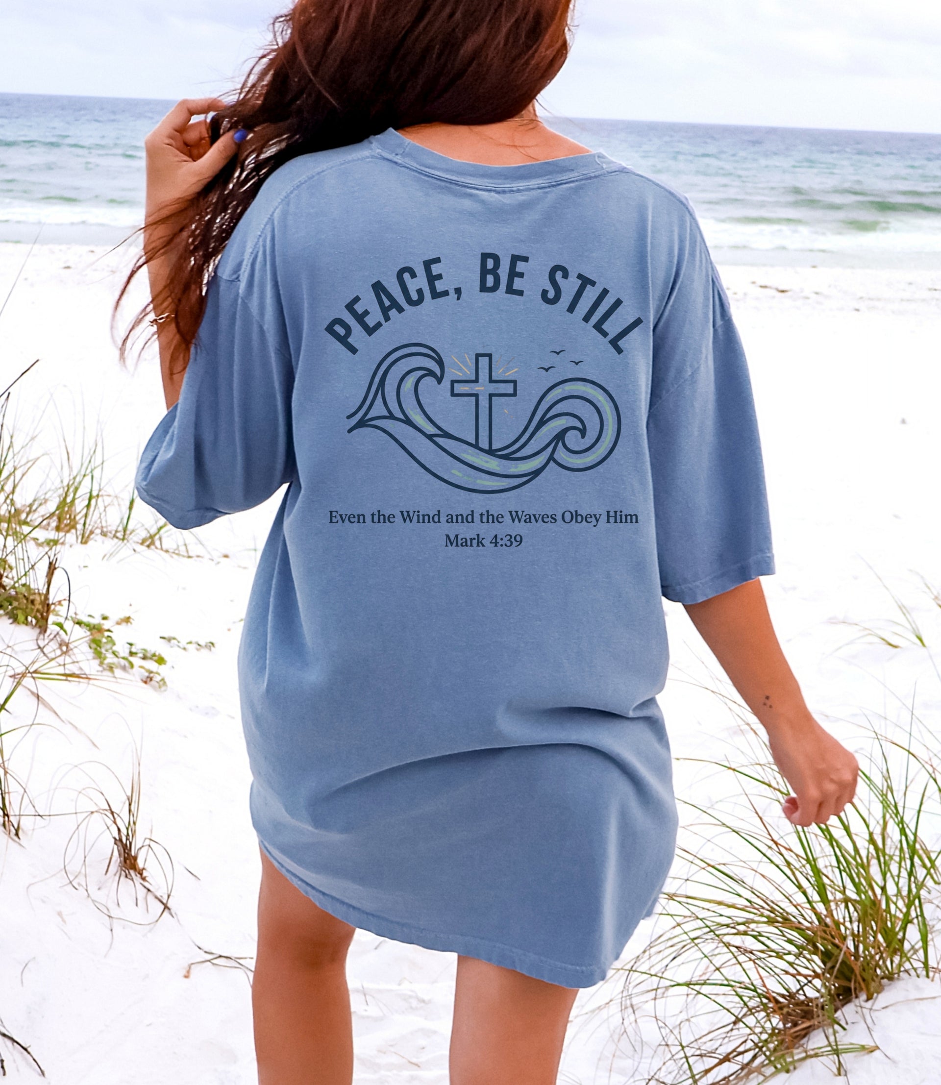 Peace Be Still T Shirt designed with waves and cross, showcasing faith on the beach with a calming design.