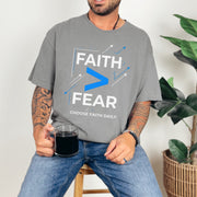 Person wearing a Faith > Fear T shirt, promoting faith over fear t shirt with a relaxed style.