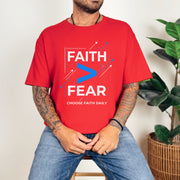 Man wearing a red Faith > Fear T shirt, promoting faith over fear t shirt with a bold design.