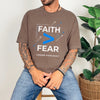 Man wearing a brown Faith > Fear T shirt promoting courage with the slogan "Choose Faith Daily".