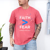 Man wearing a red Faith > Fear T shirt, promoting the message of faith over fear t shirt.
