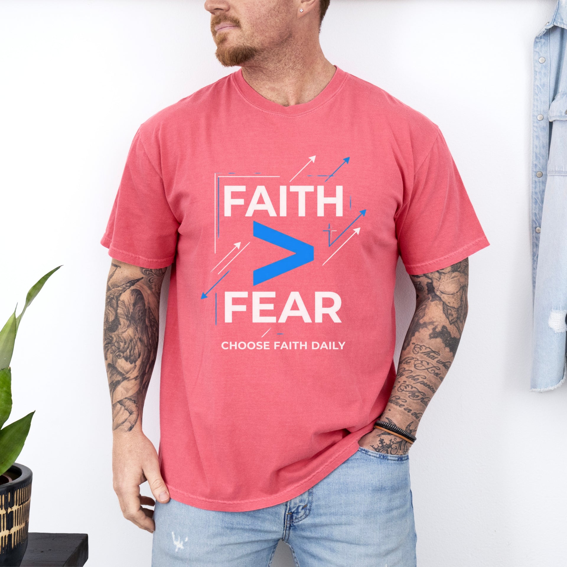 Man wearing a red Faith > Fear T shirt, promoting the message of faith over fear t shirt.