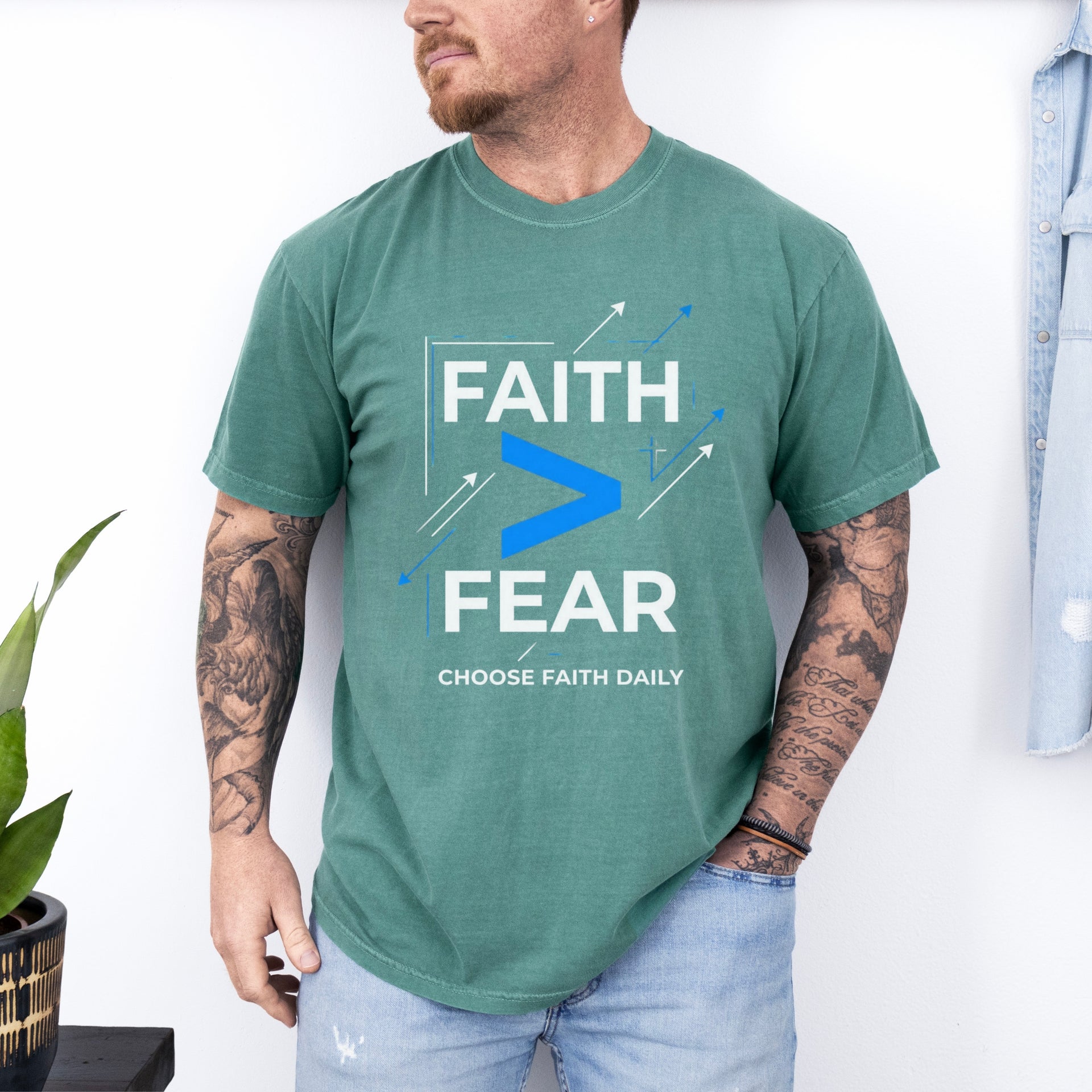 Man wearing Faith > Fear T shirt, inspiring courage with faith over fear t shirt design.