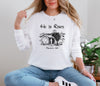 He Is Risen long sleeve t-shirt featuring Matthew 28:6 design on a woman, symbolizing resurrection and hope.
