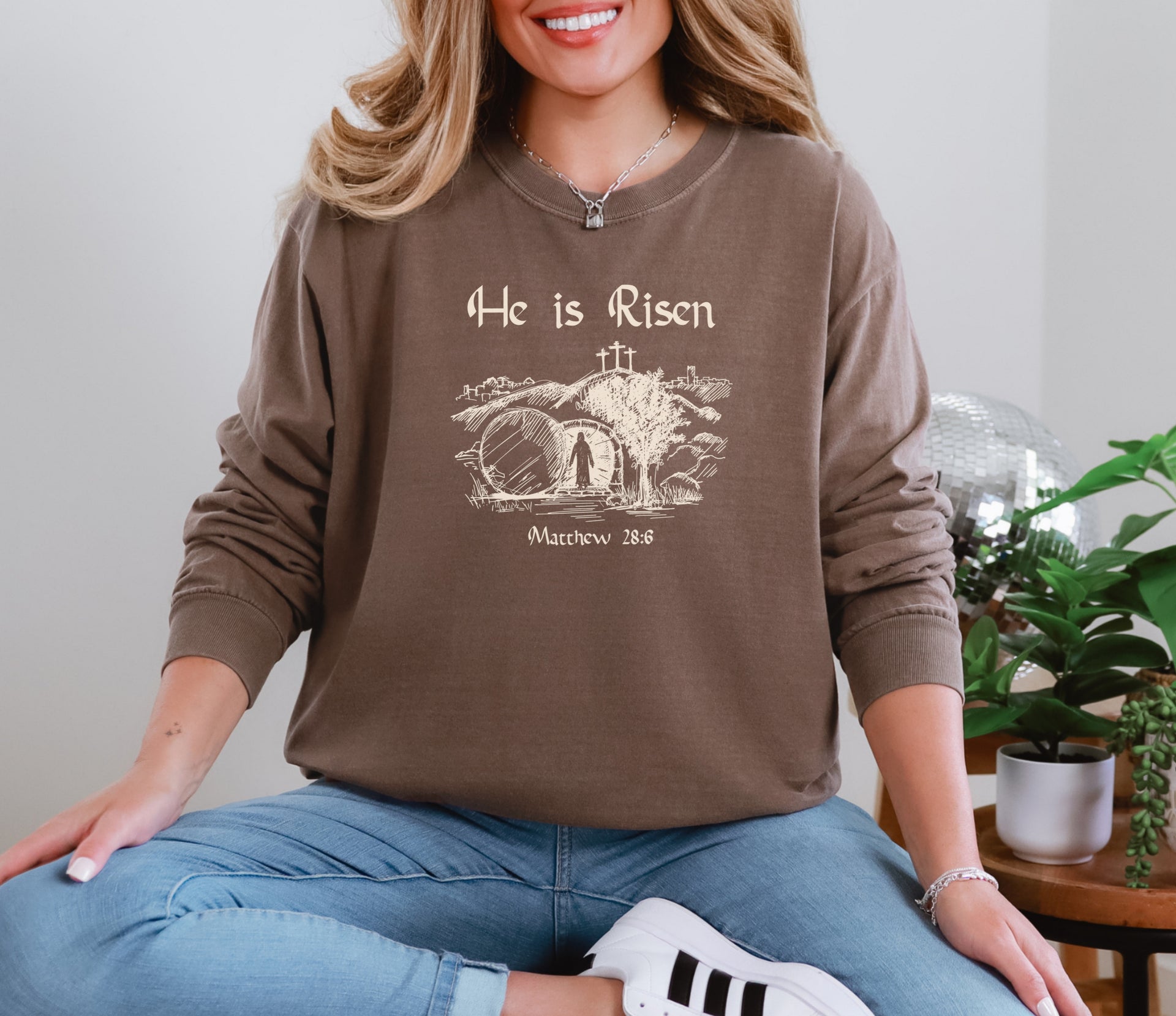 He Is Risen long sleeve t-shirt featuring a graphic design with Matthew 28:6, perfect for Easter celebrations.