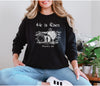 He Is Risen long sleeve t-shirt worn by a woman with a Christian design featuring Matthew 28:6.