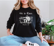 He Is Risen long sleeve t-shirt worn by a woman with a Christian design featuring Matthew 28:6.