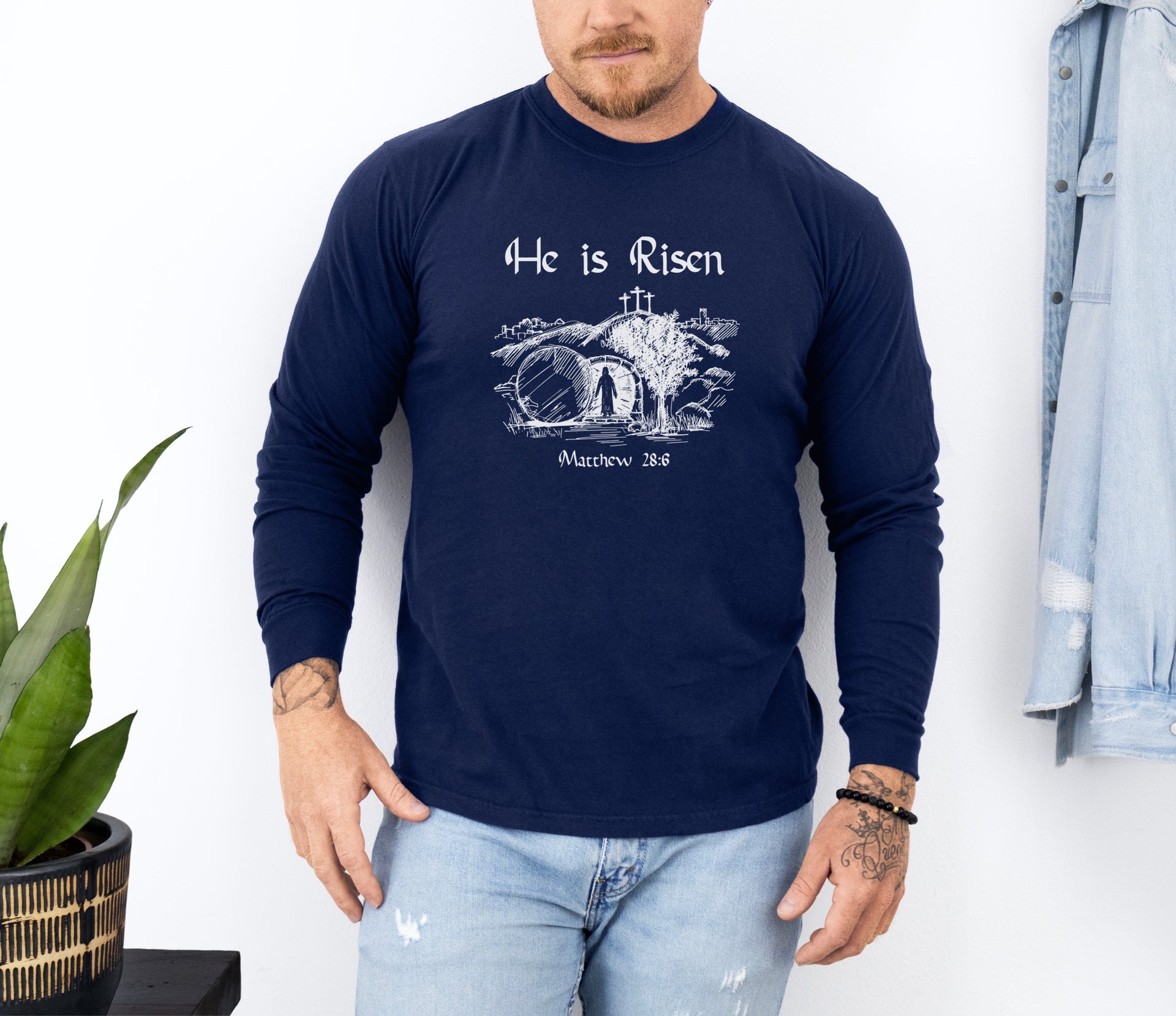 He Is Risen long sleeve t-shirt worn by a man, featuring an inspiring resurrection design.