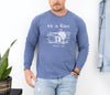 He Is Risen long sleeve t-shirt worn by a man, featuring a Christian design with Matthew 28:6, in a relaxed fit.