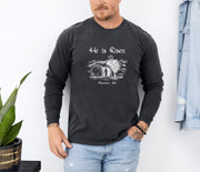 He Is Risen long sleeve t-shirt featuring a resurrection graphic and Matthew 28:6, perfect for celebrating Easter.