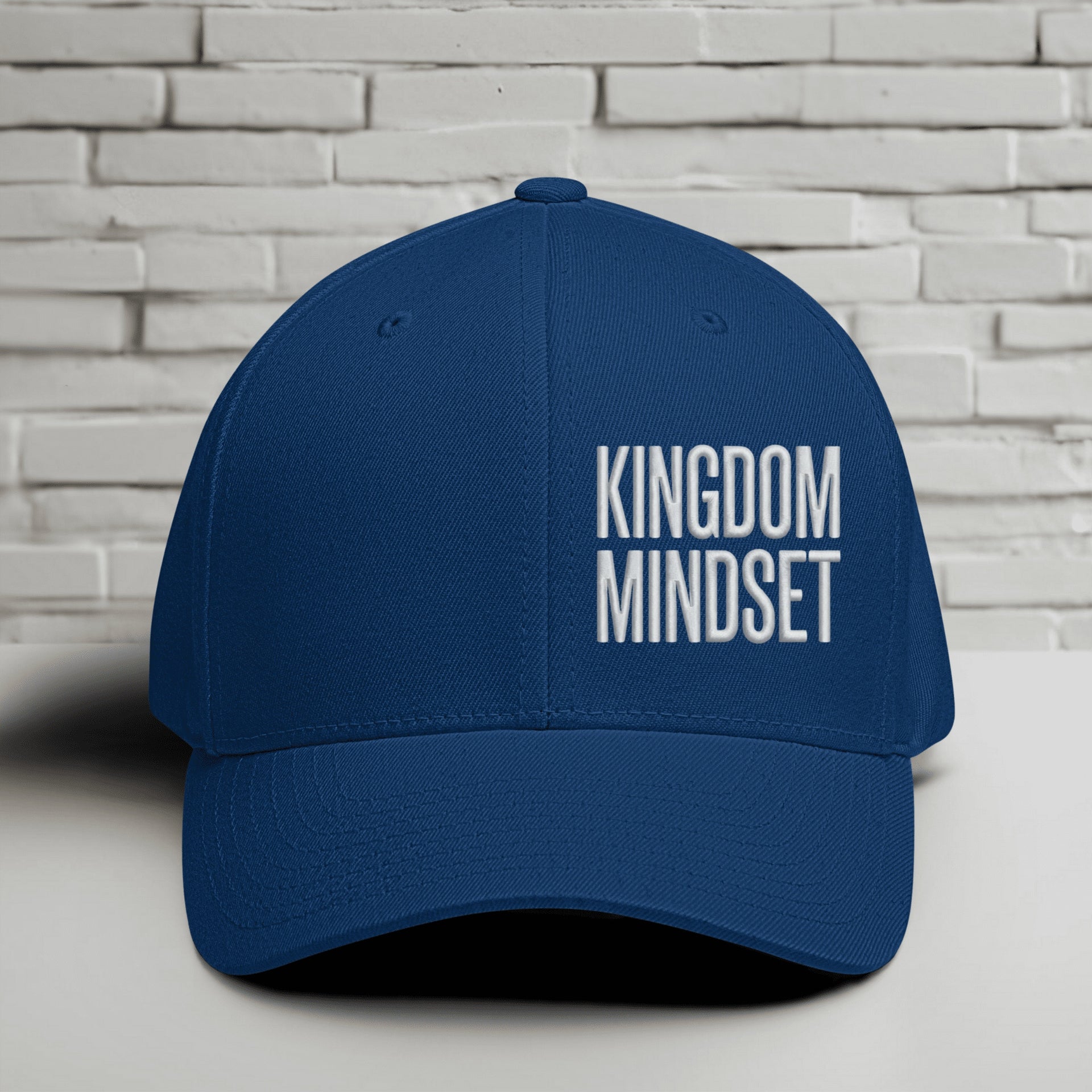 Flexfit Kingdom Mindset hat in royal blue with white embroidery on a minimalist background.