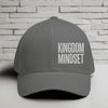 Flexfit Kingdom Mindset hat in grey with white embroidery against a brick background.