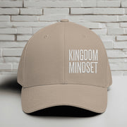 Flexfit Kingdom Mindset hat in khaki with white embroidery on a textured background.