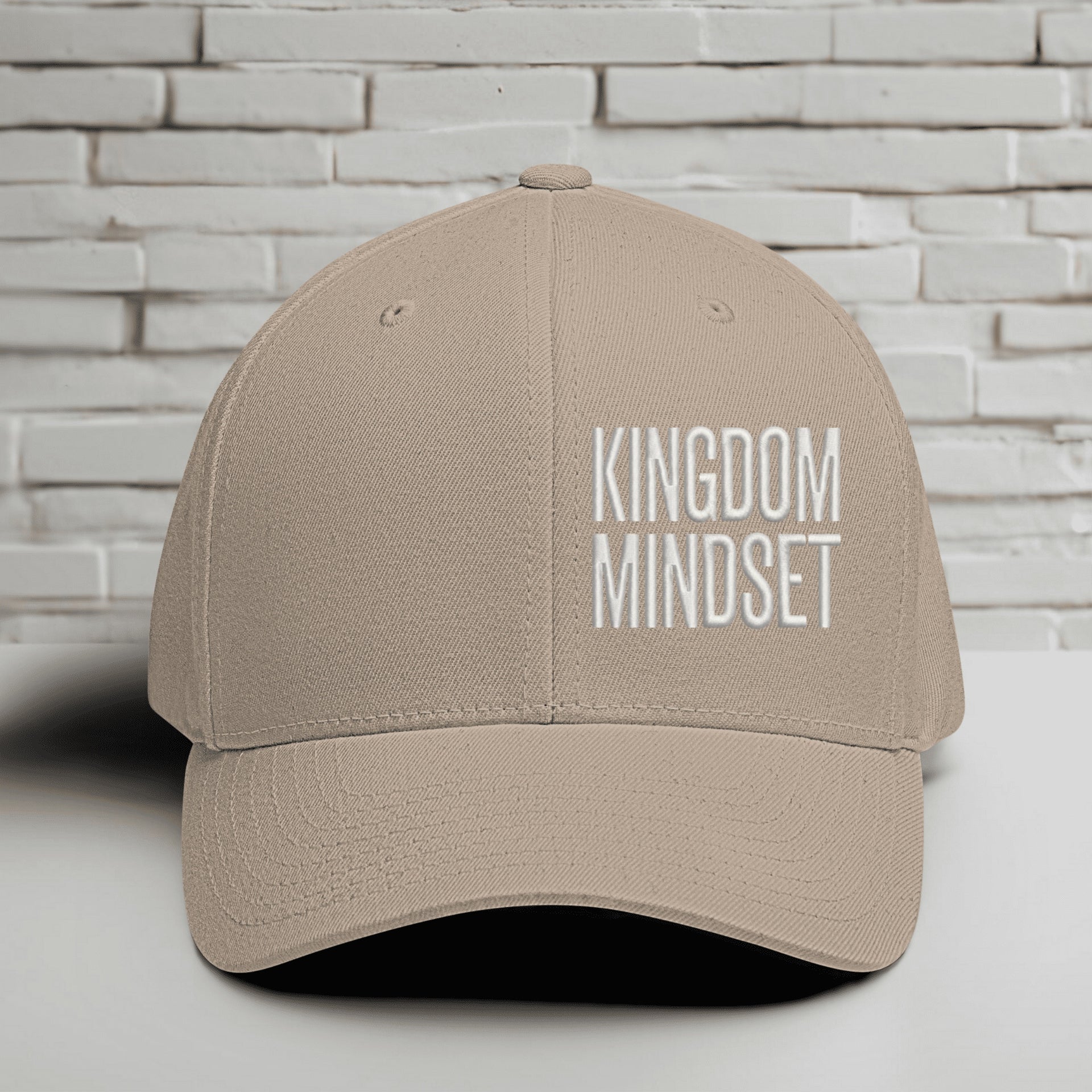 Flexfit Kingdom Mindset hat in khaki with white embroidery on a textured background.