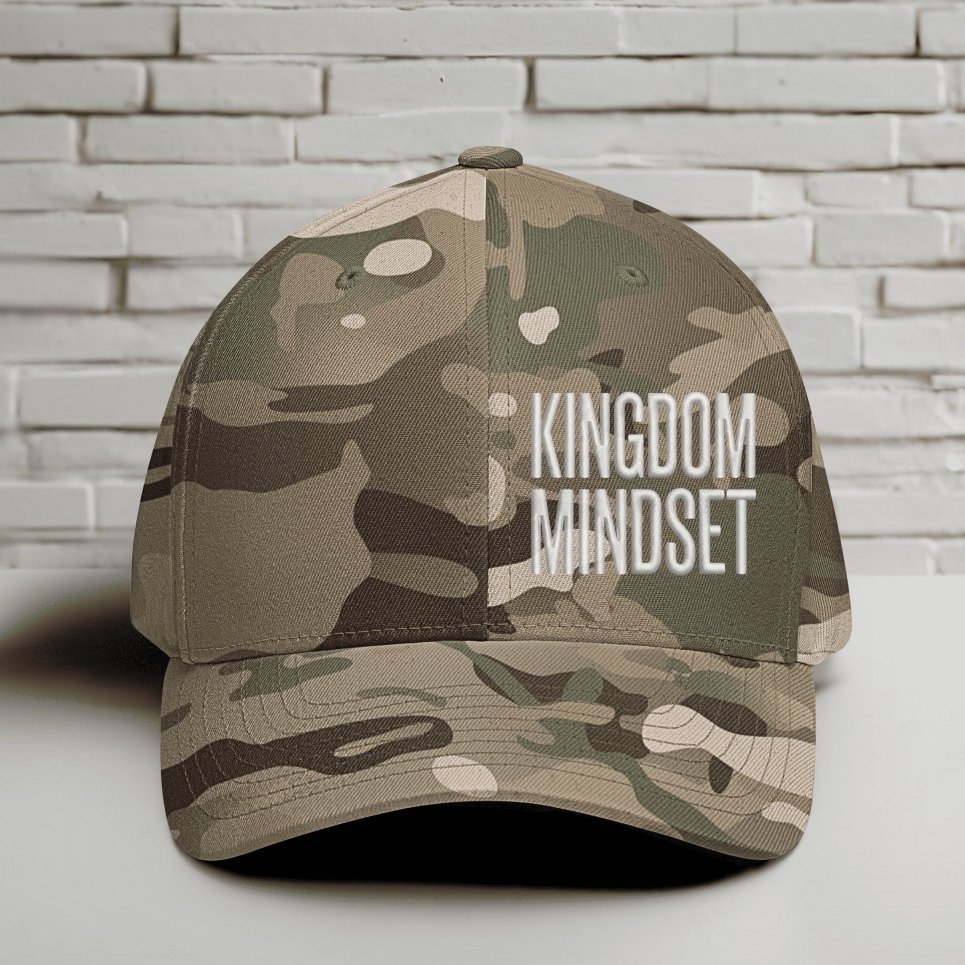 Flexfit Kingdom Mindset hat in Multicam Green with white lettering on a camouflage background.